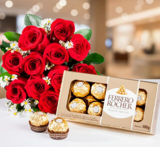 Ramo de rosas rojas con flores blancas pequeñas junto a una caja abierta de chocolates Ferrero Rocher sobre fondo desenfocado