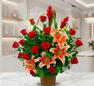 Arreglo floral exótico 'Me Encantas' con lirios tigre y rosas rojas vibrantes, sobre una superficie de mármol pulido en un en