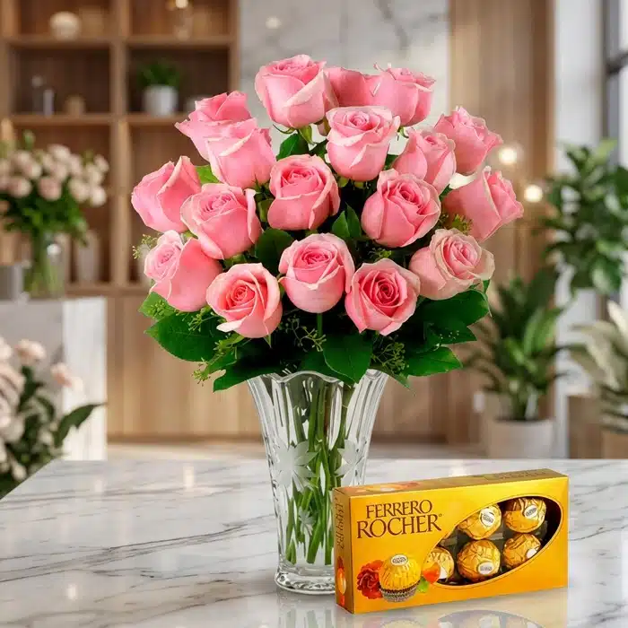 Jarrón Decídete: Rosas Rosadas Frescas y Chocolates Ferrero Rocher Jarrón Decídete con un exuberante arreglo de rosas rosadas frescas y vibrantes, acompañado de una caja de chocolates Ferrero